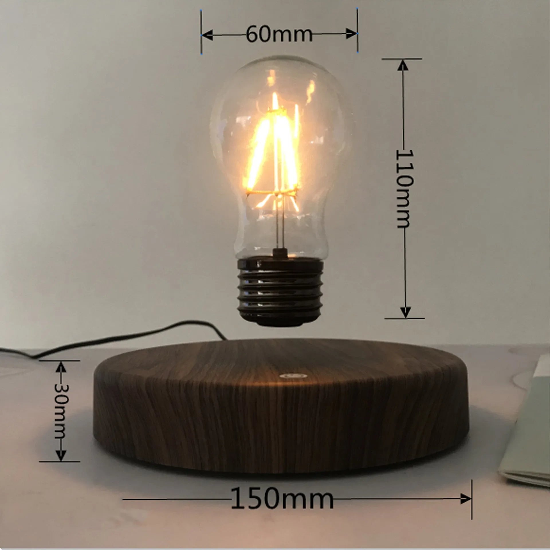 Magnetic levitation bulb night light floating above wooden base
