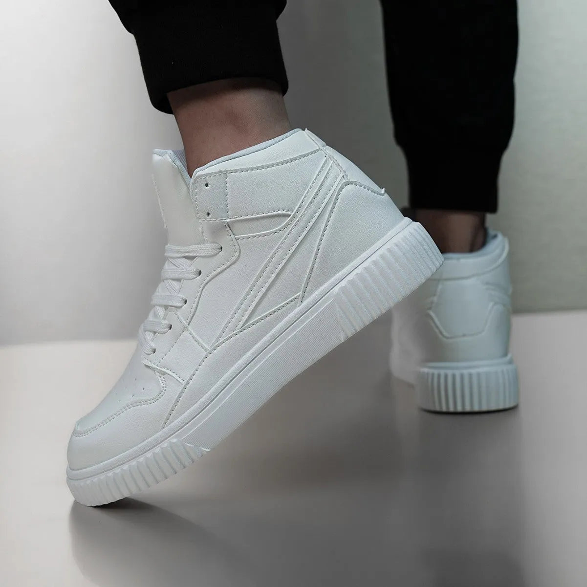 Men's white casual shoes with round toe and microfiber upper on a plain background.