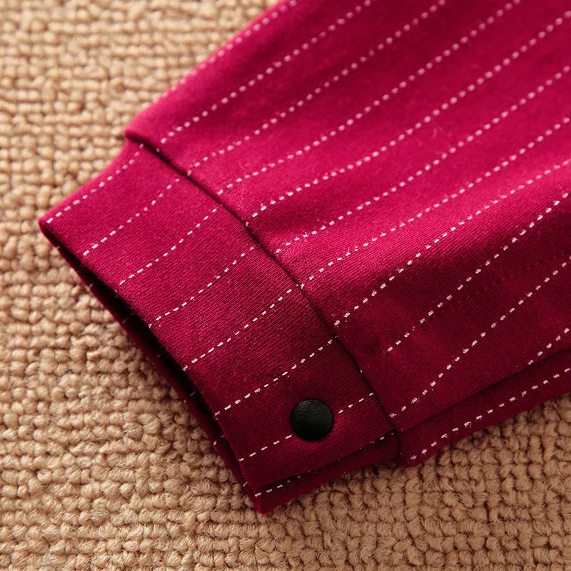 Baby boy wearing a wine red cotton gentleman jumpsuit with long sleeves and single-breasted closure.