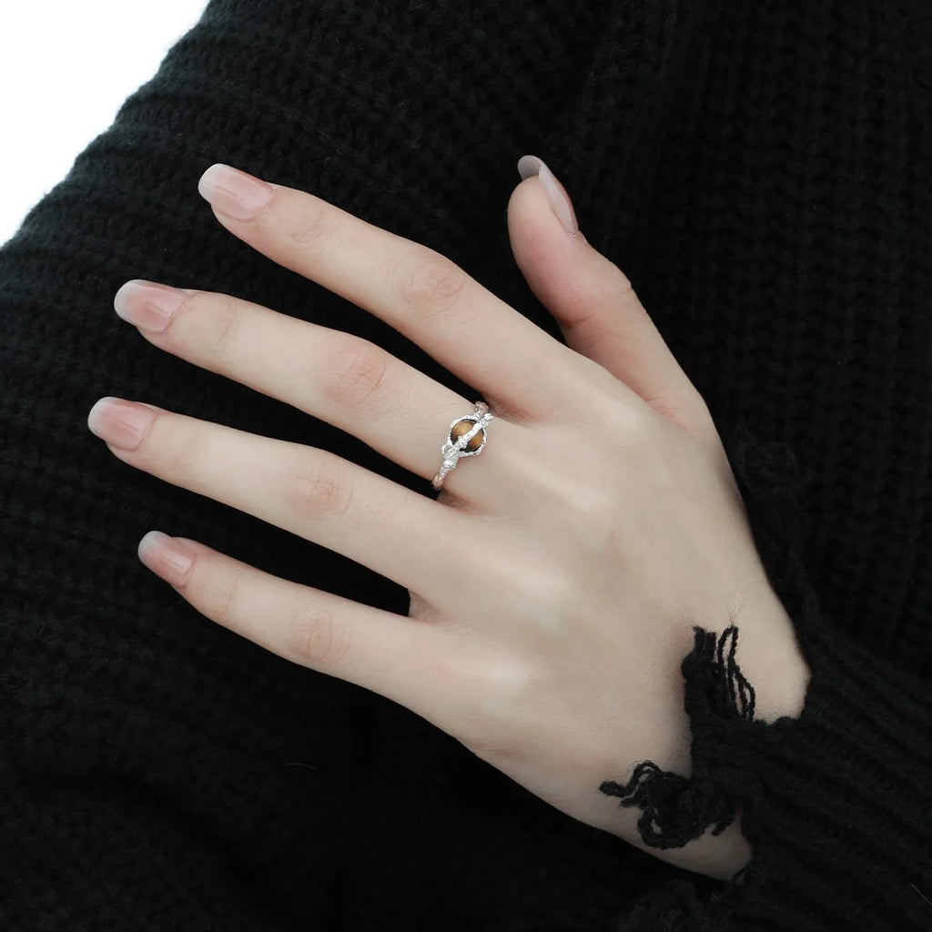 Silver open ring with Saturn design and white gold plating, shown with adjustable opening.