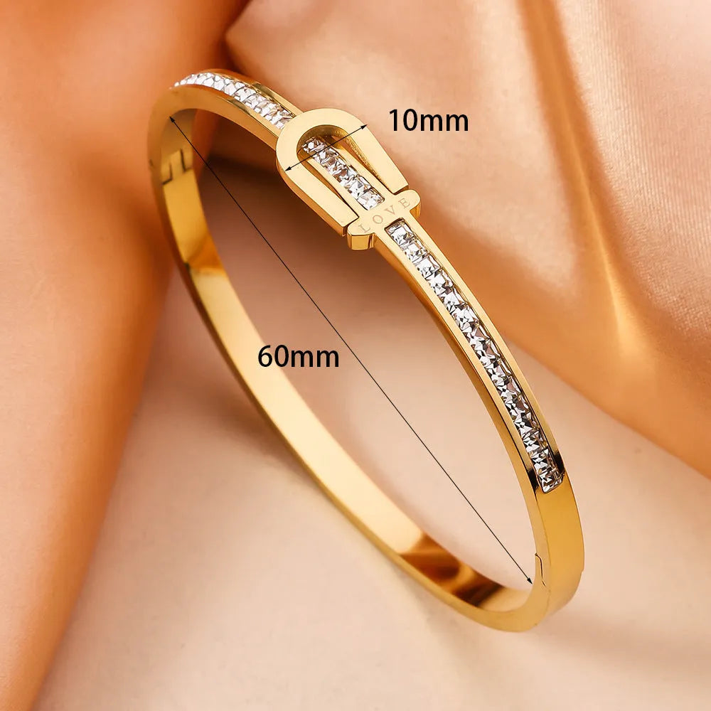 Gold plated titanium steel bangle bracelet with gang drill style, available in gold and steel colours.