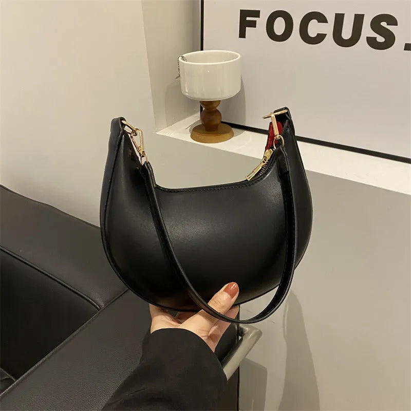 Round one-shoulder underarm bag in PU material, shown in green colour with visible sewing lines and a single strap.