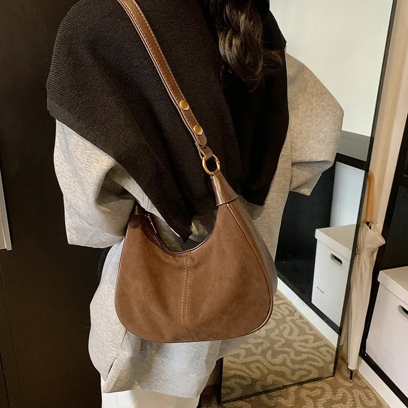 Retro commuter crossbody bag in PU with oval shape and three-dimensional pocket, shown in black, wine red, dark brown, or brown.