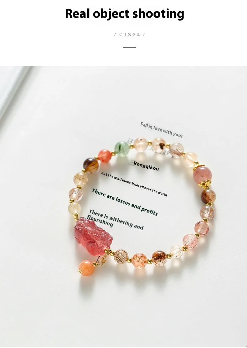 Natural strawberry quartz and copper bracelet with pearl accents on a wrist.