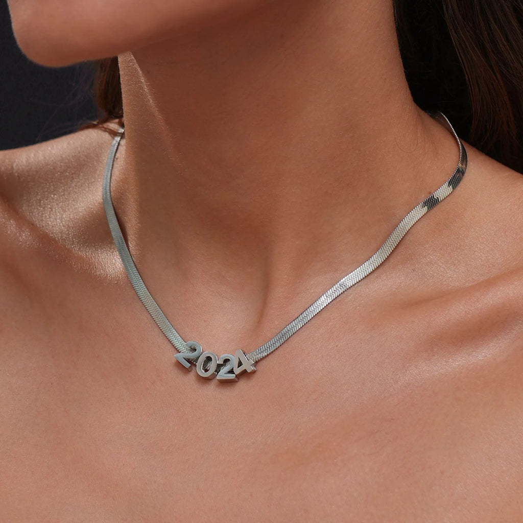 Gold electroplated titanium steel necklace with the letter 'A' pendant on a 40.5 cm chain.