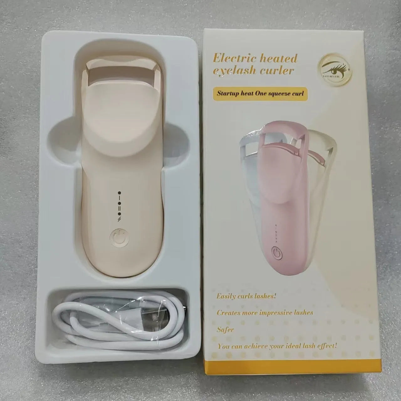 Electric heating eyelash curler with USB charging cable in cream white, pink, or apricot colours