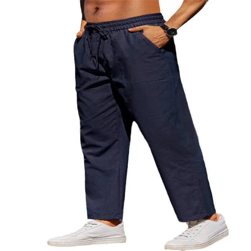 Men's straight-leg linen trousers with an elastic waistband in a solid colour.