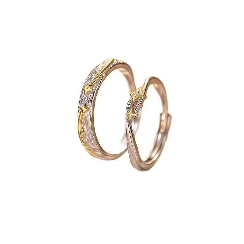 Pair of copper electroplated meteor shower star couple rings with adjustable opening on a flat surface