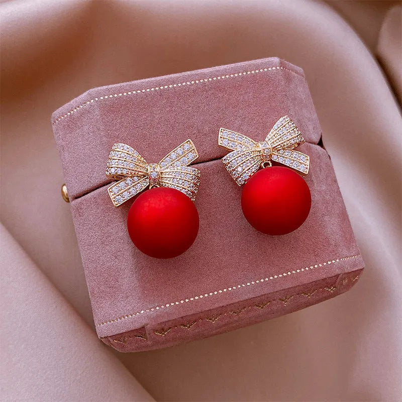 Women's bowknot stud earrings with rhinestone detail in Blue Pink Red White, alloy electroplated, individually packed.