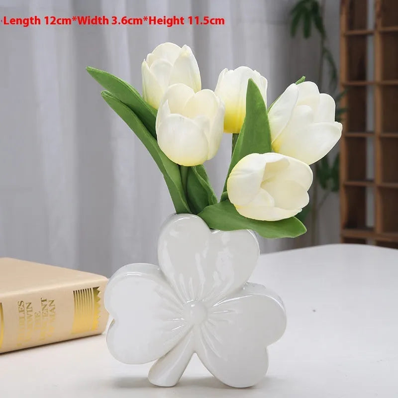 Clover white porcelain ceramic vase in European style on a desk.