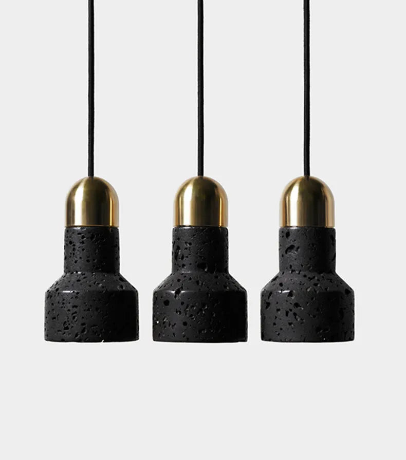 Industrial style black iron chandelier light hanging above a wooden bar table.