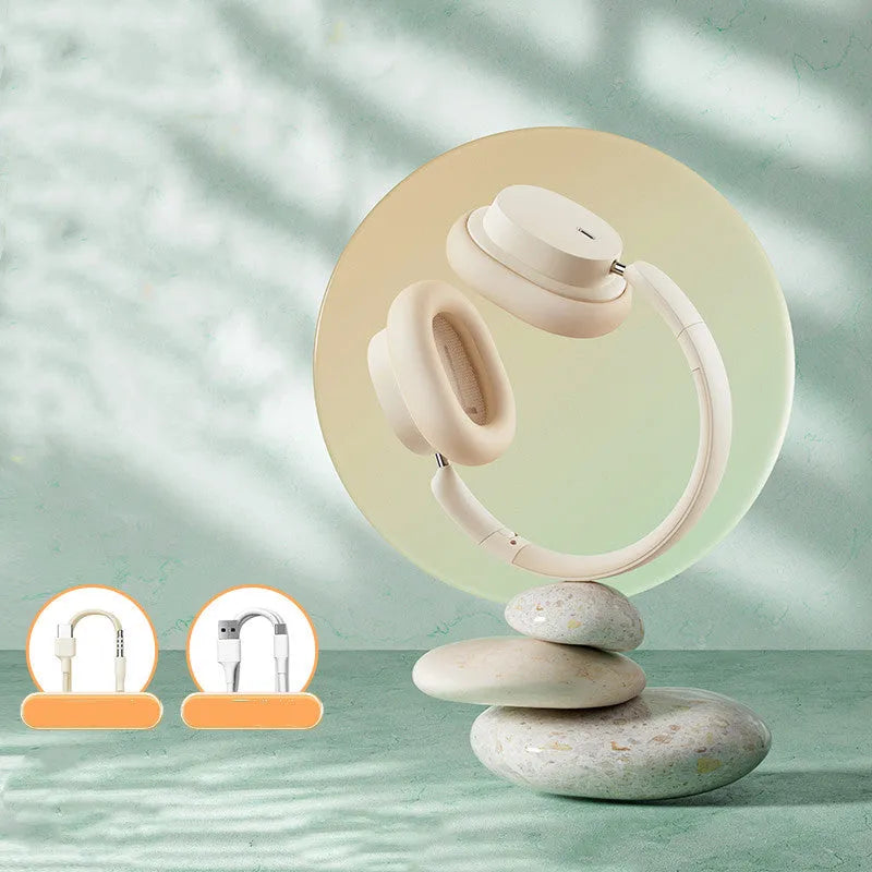 Beige wireless Bluetooth over-ear headphones with a headband, shown with a Type-C charging cable.