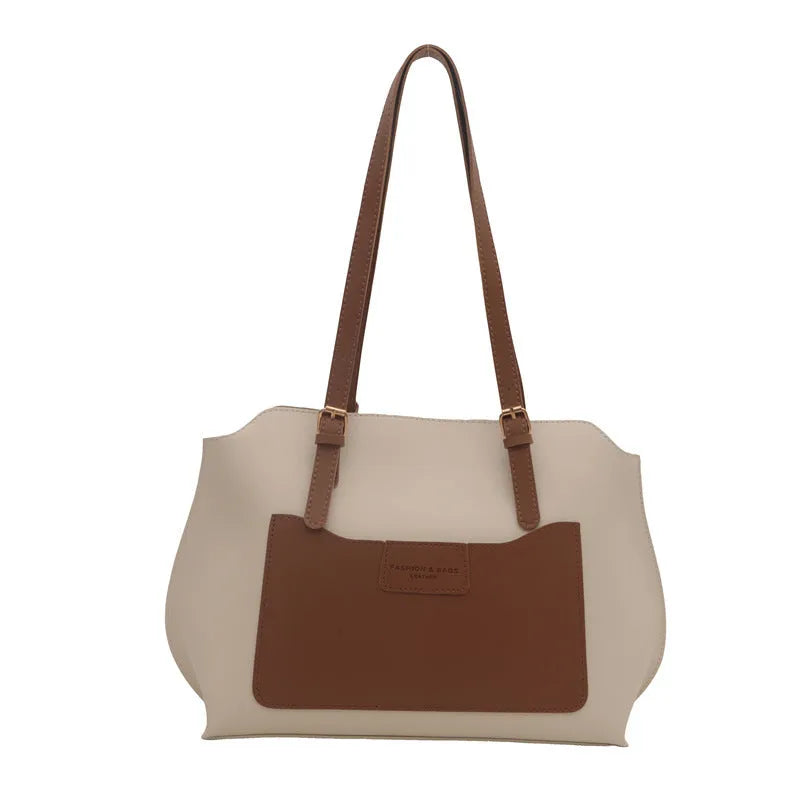 Women's square PU tote bag in black with double straps, showing external sandwich pocket and sewing line detail.