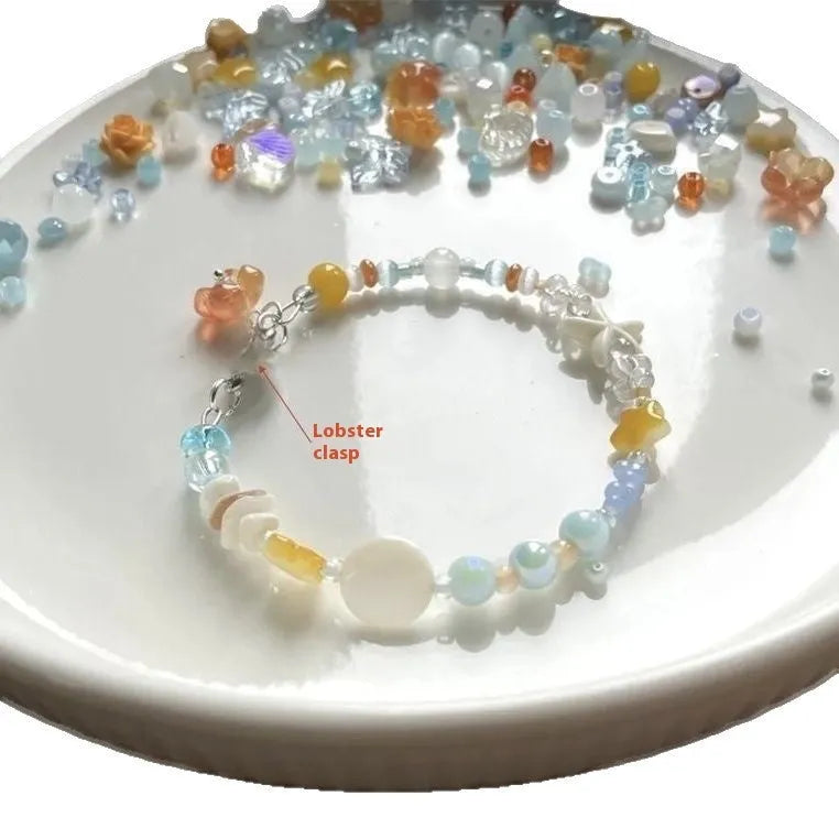 Orange alloy charm bracelet for women with a diamond-shaped charm and round bead details on a silver-tone chain.