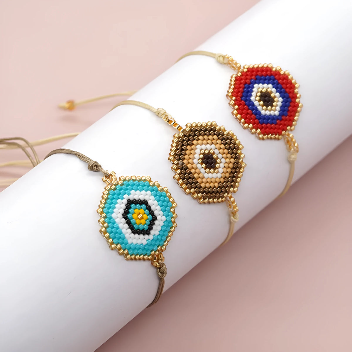 Hand-woven glass bead bracelet with blue eyes devil eyes motif on white background