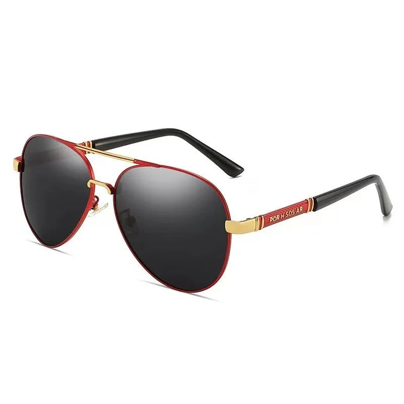 Men's gold metal frame polarised sunglasses with dragon and phoenix decoration and grey lenses on a table.