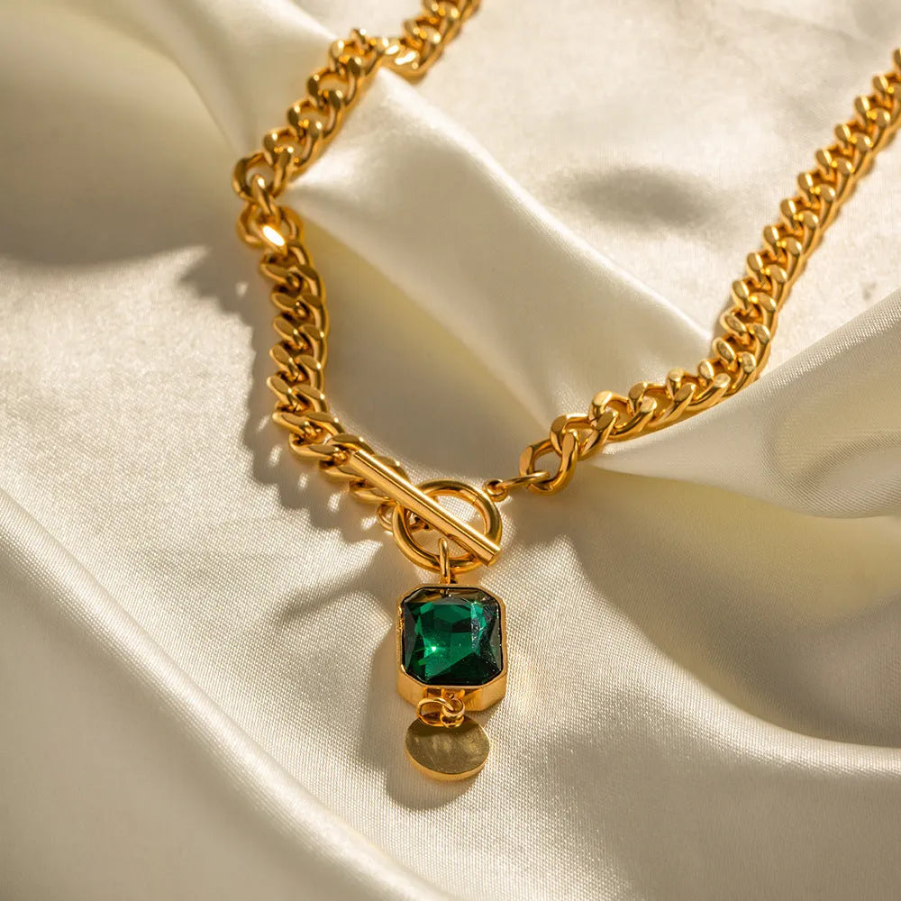 Gold geometric zircon pendant necklace with Cuban chain on white background