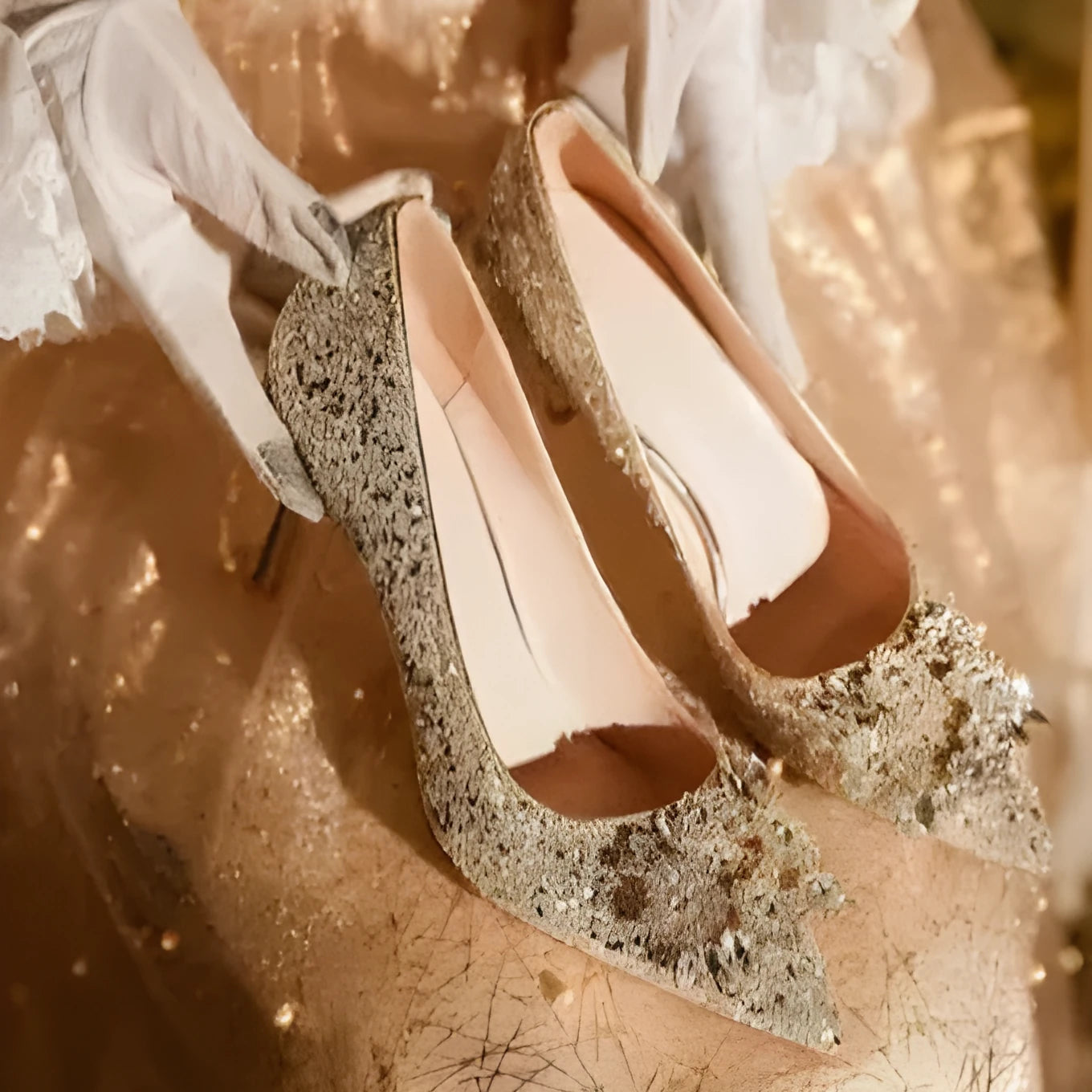 Champagne coloured pointed toe bridal shoes with rhinestone floral pattern on a fine heel.