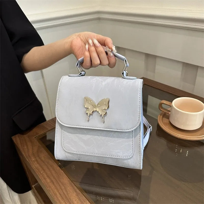 Women's white PU leather hand-carry backpack with bow detail and mobile phone compartment