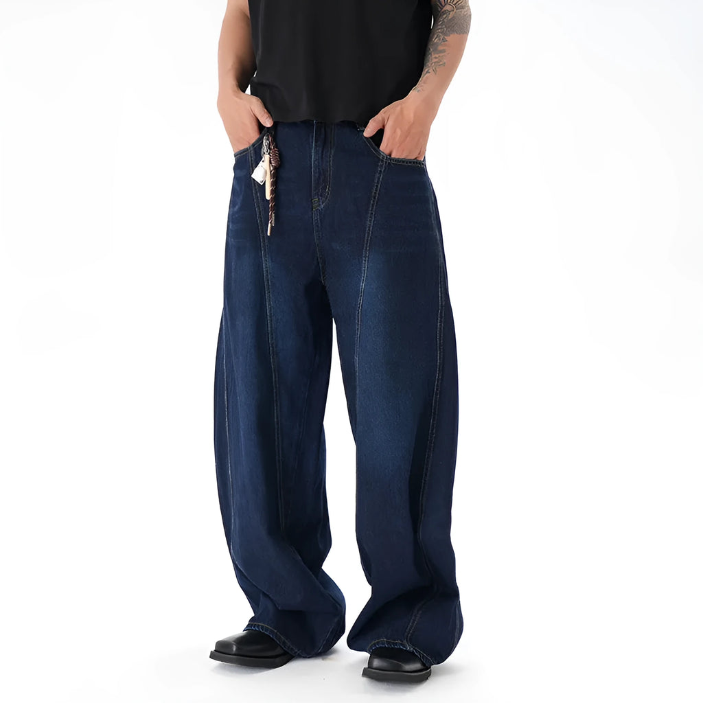 Dark blue washed distressed denim wide leg machete jeans laid flat, showing the wide leg cut and textured finish.