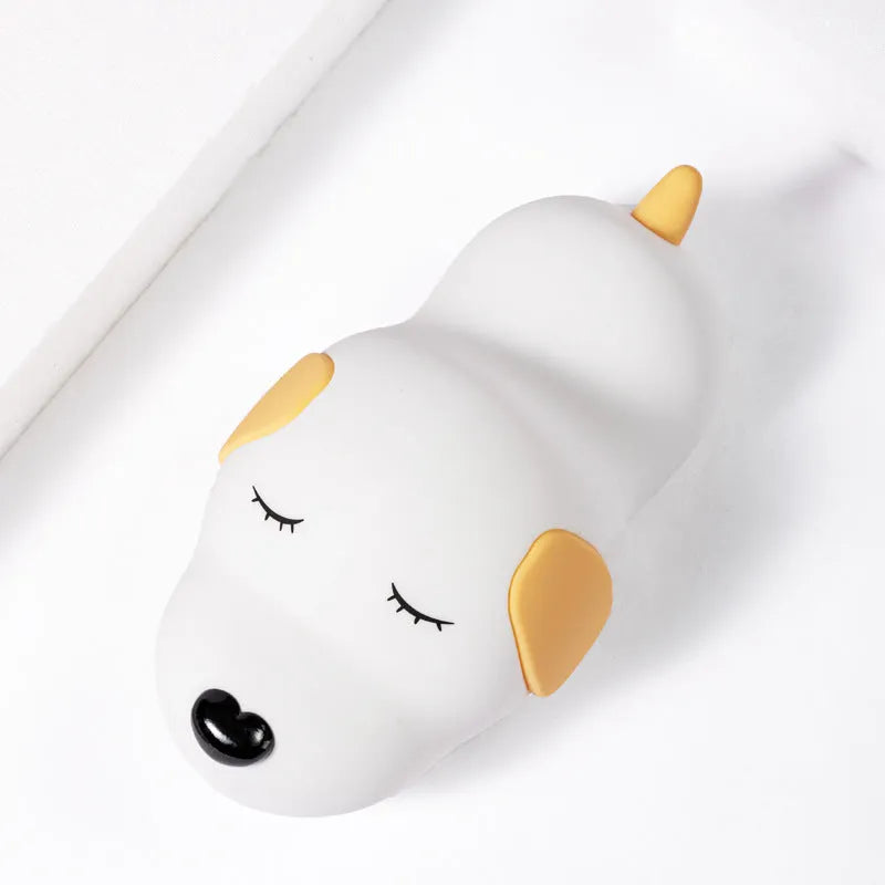 Silicone cartoon dog night lamp in two colours with a USB charging cable.