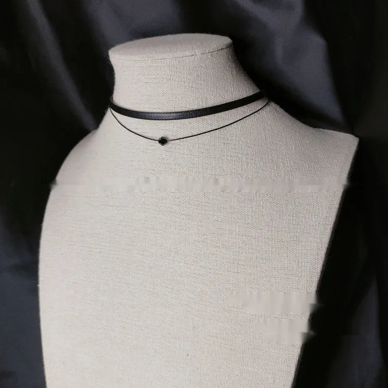 Retro leather rope double layer necklace with glass crystal beads and stainless steel buckle on a neutral background