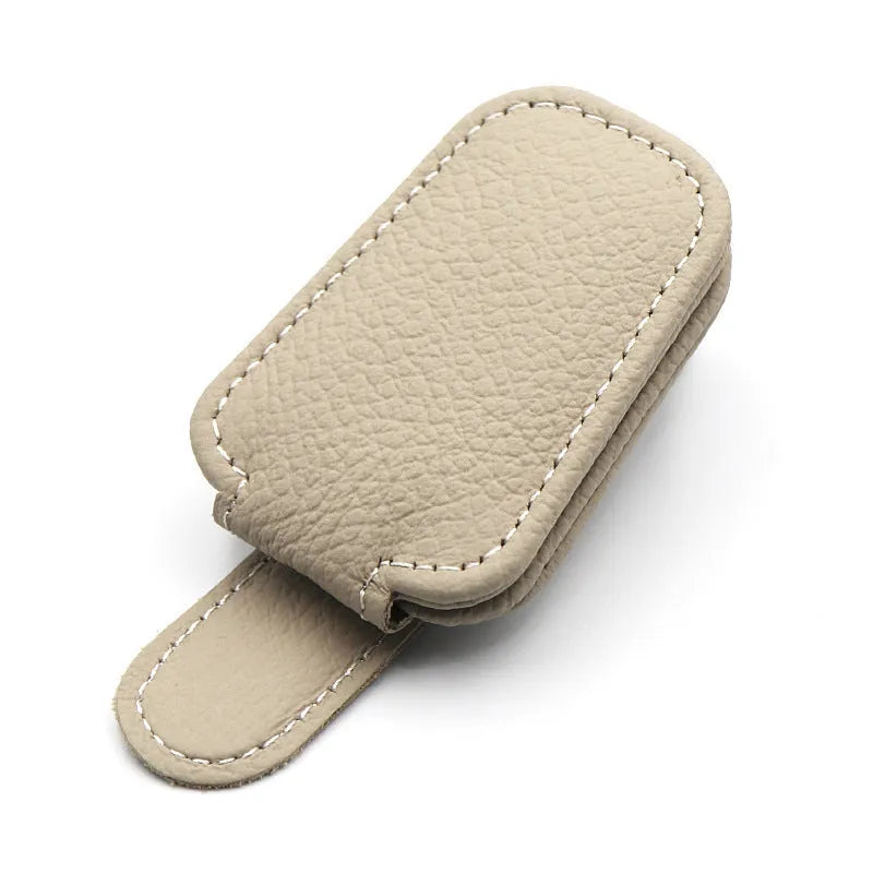 PU leather car sunglasses clip holder mounted on a grey sun visor.