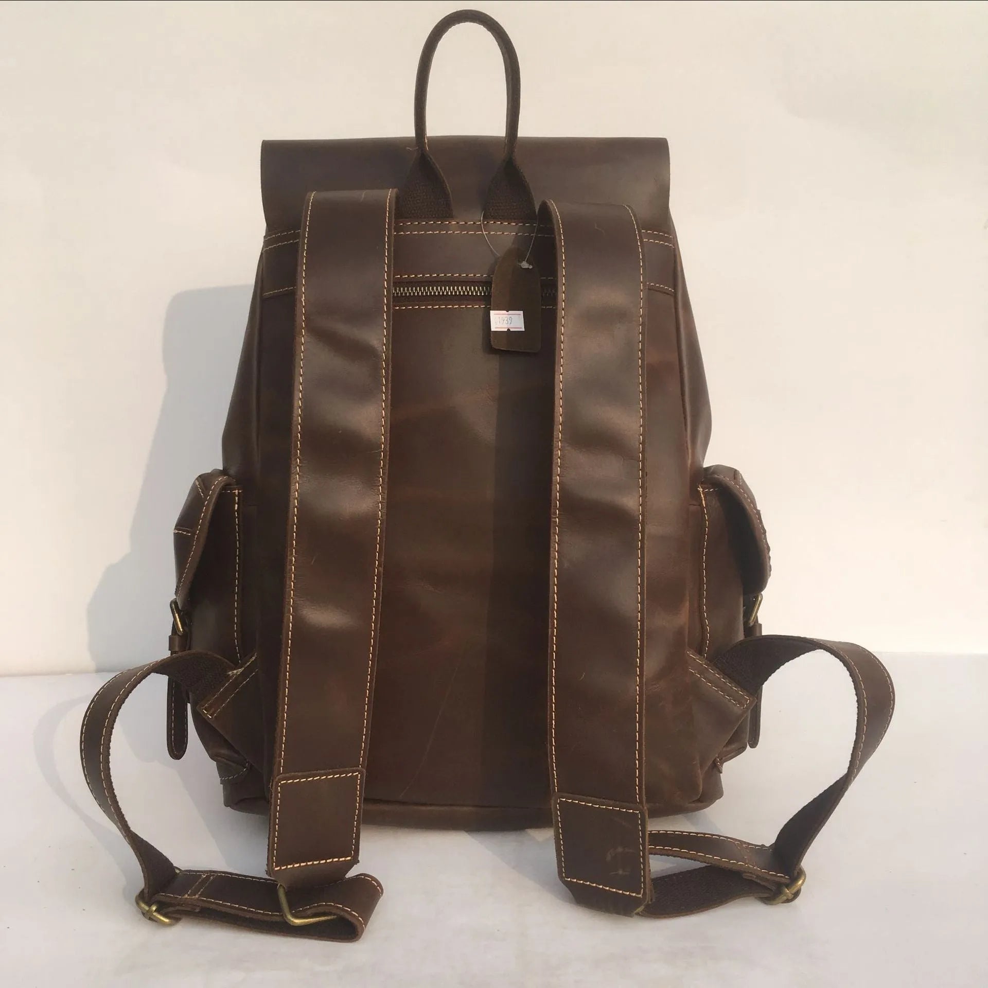 Brown men's leather backpack made from top-layer cowhide with an air pillow belt back system.