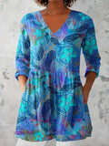 Women's retro-style slim-fit long-sleeved top with a colourful digital print pattern, shown on a model.