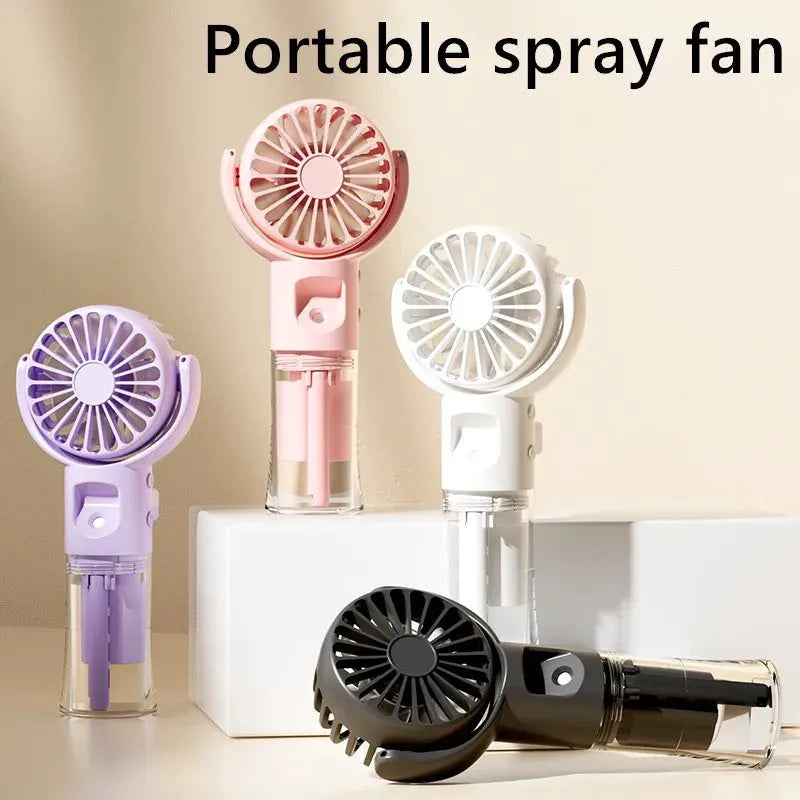 Handheld misting fan with transparent water tank showing multiple colour options including black, white, and pink