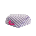 Striped orange plush pet bed for a small dog on a wooden floor.