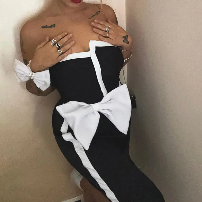 Women's black and white colour-blocking swimsuit with asymmetrical bow detail and tube top design