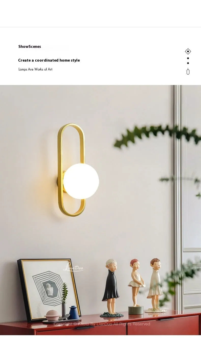 Modern minimalist wall lamp with clear glass shade and black iron mount, showing three light colour settings.