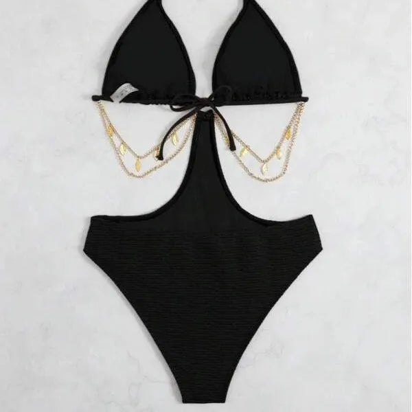 Women's black bikini swimsuit with gold chain decoration on a mannequin.