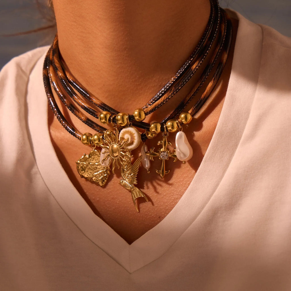 Geometric stainless steel necklace with leopard leather accents on pendant and gold-plated chain