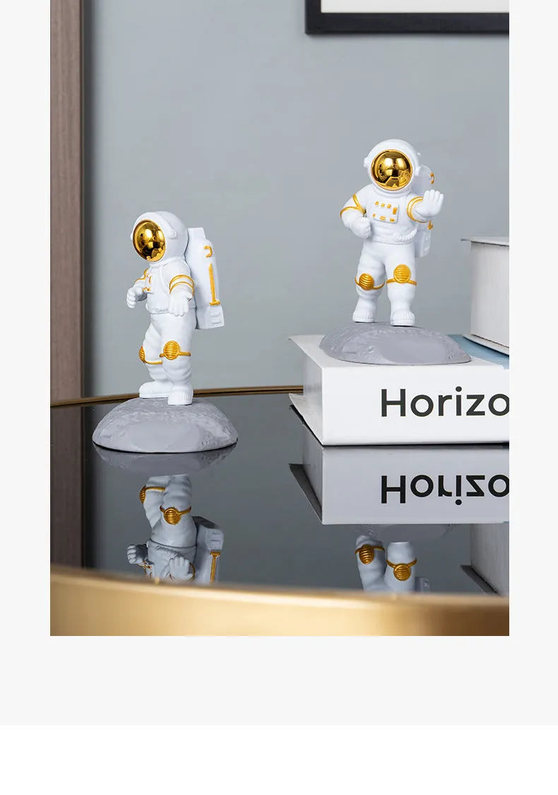 Astronaut decoration spaceman plastic mobile phone holder in blue, gold, and silver colours for lazy binge-watching