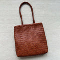 Brown handmade woven tote bag made of genuine cowhide leather with a three-dimensional pocket.