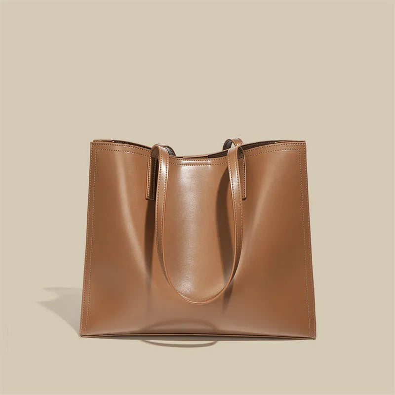 Brown genuine leather women's handbag with single shoulder strap and horizontal square shape