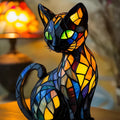 Resin cat-shaped LED night light with button switch on a wooden table
