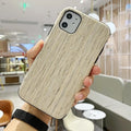 A natural wooden mobile phone case for iPhone, shown in rosewood colour on a table.