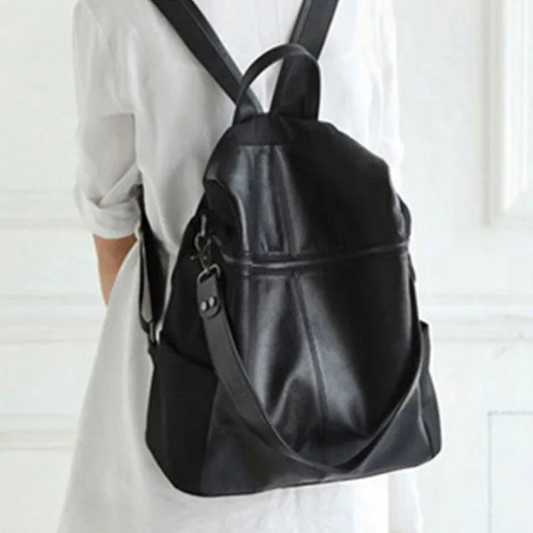Genuine leather retro-style women's backpack showing front sandwich pocket and brown leather texture.