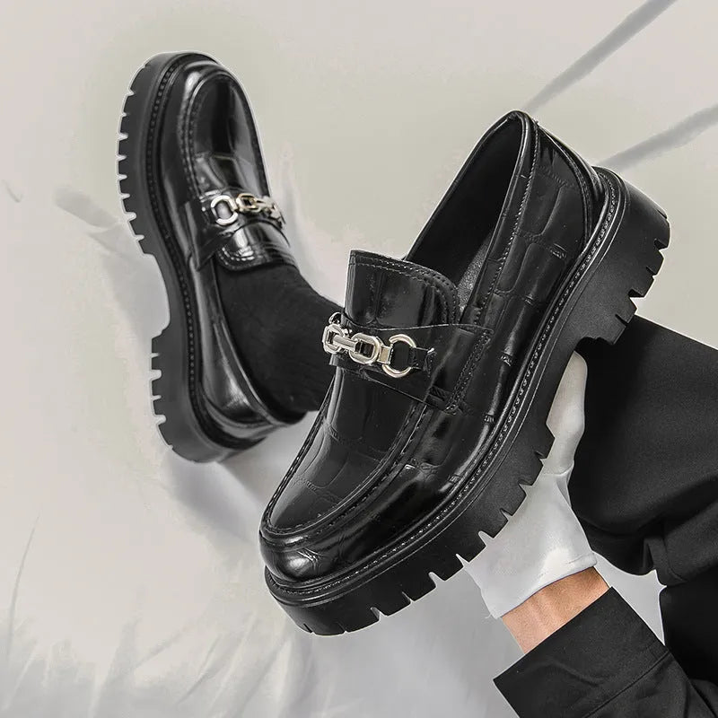 Men's black crocodile pattern leather loafers with a platform sole and flat heel.