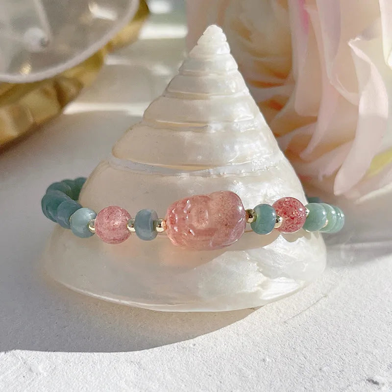 Women's simple jade bracelet with blue gourd charm and silver peace buckle on a beaded strand.