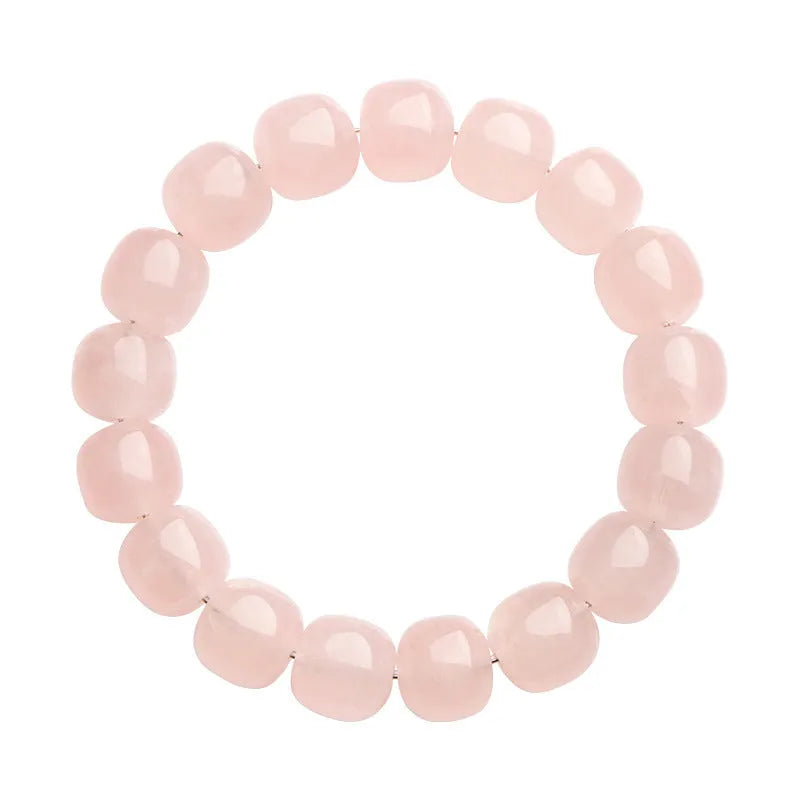 Pink crystal barrel bead bracelet with geometric beads on an elastic cord