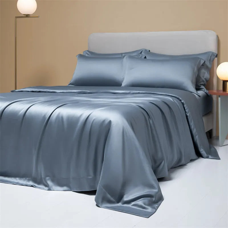 Luxury Lenzing Tencel quilt cover and pillowcases in Aurora Blue on a bed, showing satin weave texture.