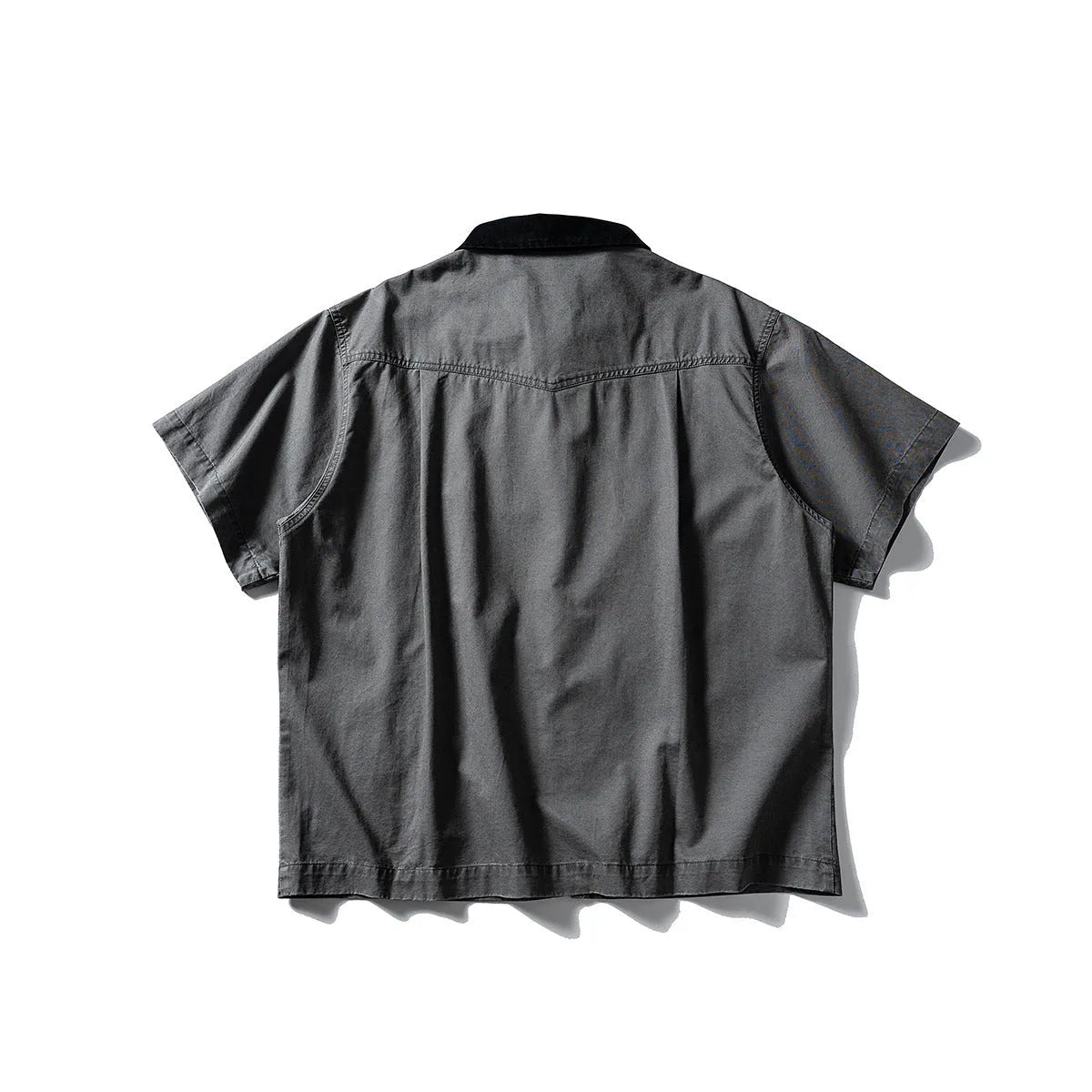 Short sleeve loose cotton overalls shirt in khaki colour on a hanger