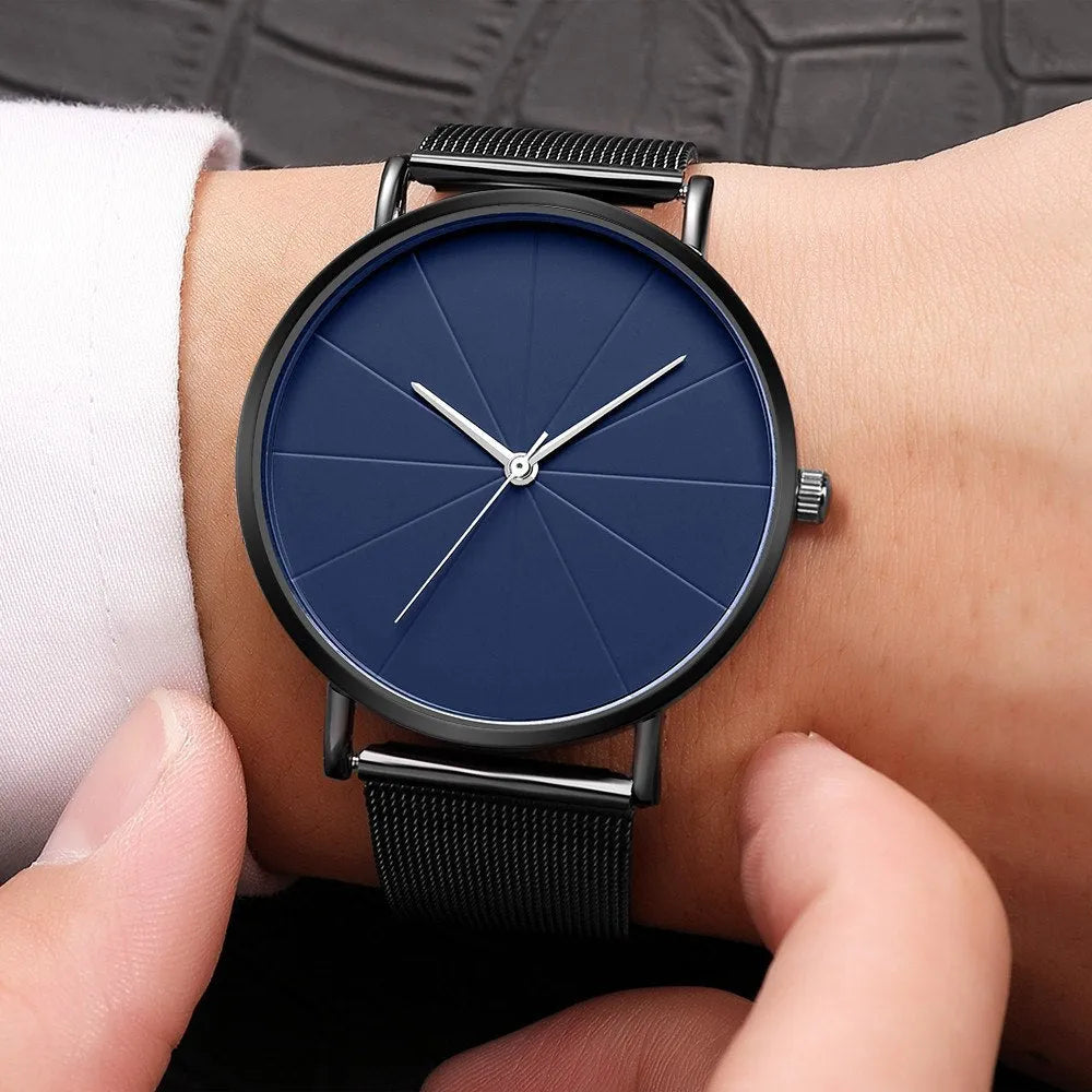 Stainless steel men's quartz watch with round dial, date window, and adjustable pin buckle on a white background.