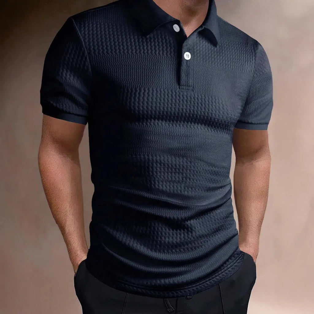 Man wearing a loose-fit striped polo shirt in a light blue colour, showing asymmetric detail and short sleeves.