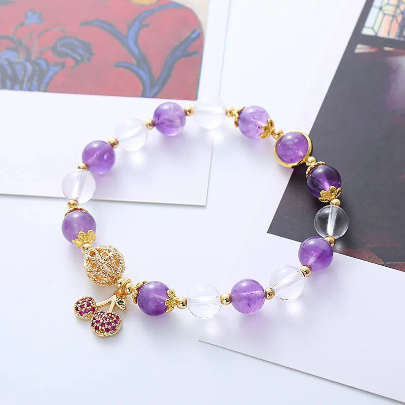 Handmade women's purple crystal bracelet with a micro-inlaid cherry flower charm.