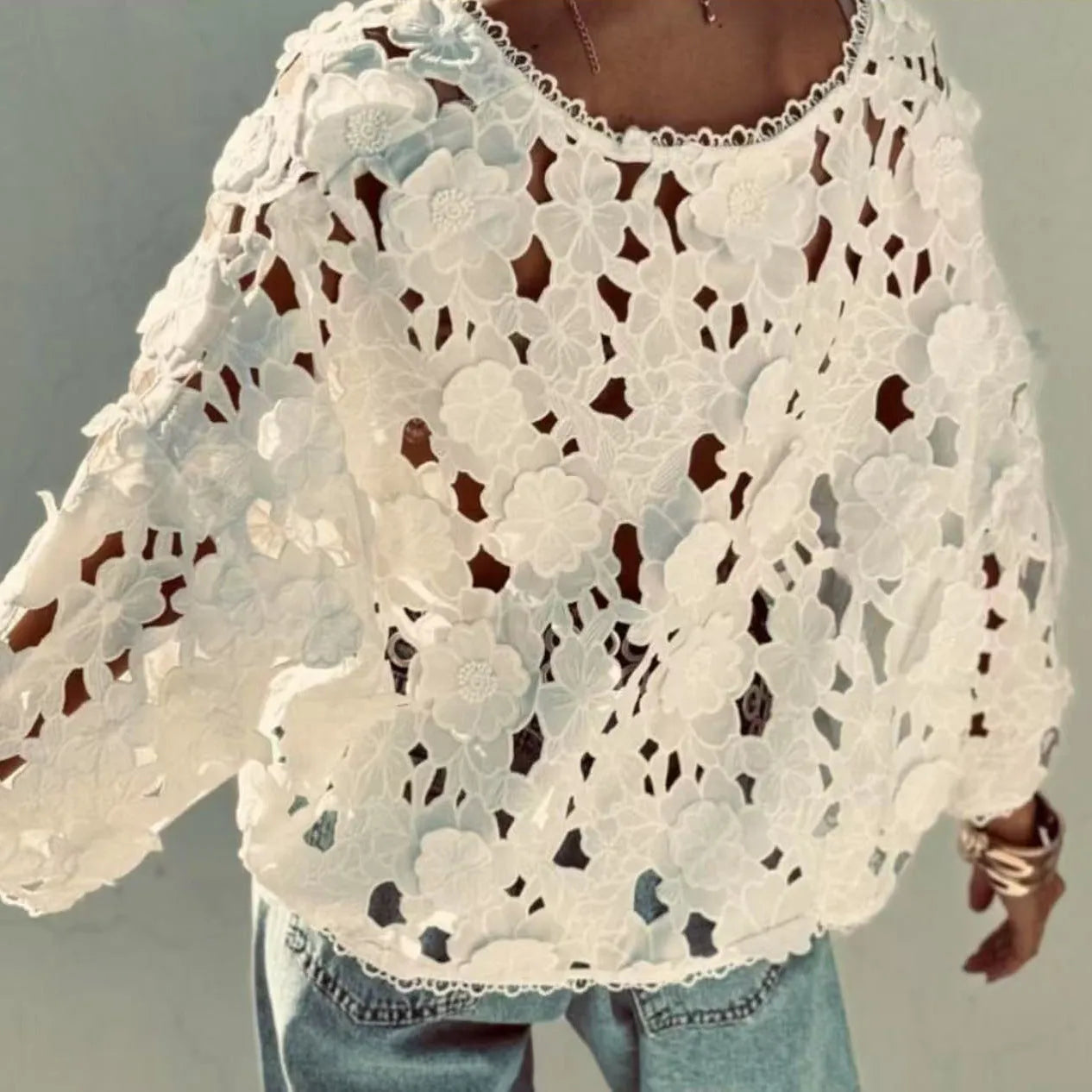 Loose fit lace cardigan with V-neck, long sleeves, and a 3D hollow flower decoration in black colour.